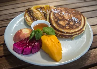 Pancakes with local Cambodian fruits and honey at New Leaf Eatery Siem Reap