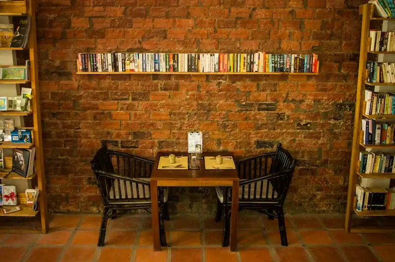 New Leaf Eatery interior showing dining table with book shelves in Siem Reap Cambodia